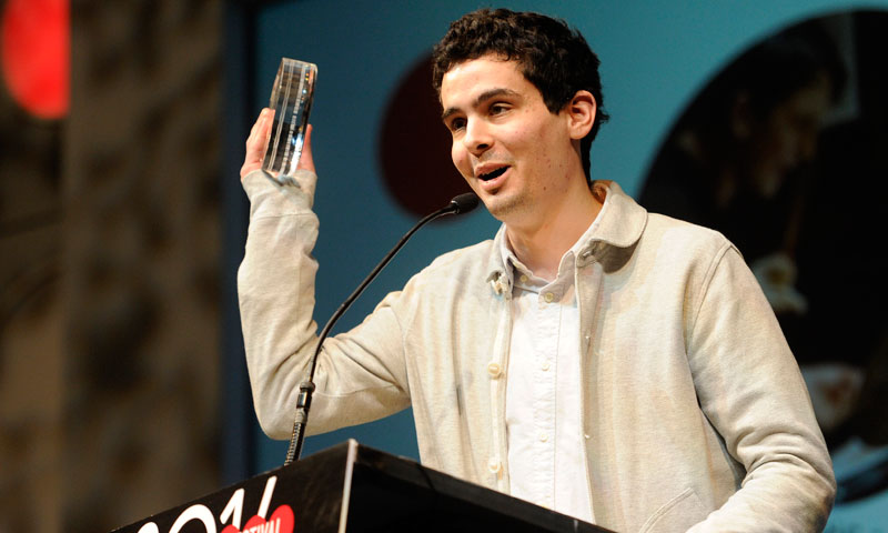 Director Damien Chazelle celebrates winning the Audience Award for 'Whiplash' at the 2014 Sundance Film Festival  — Photo by AFP