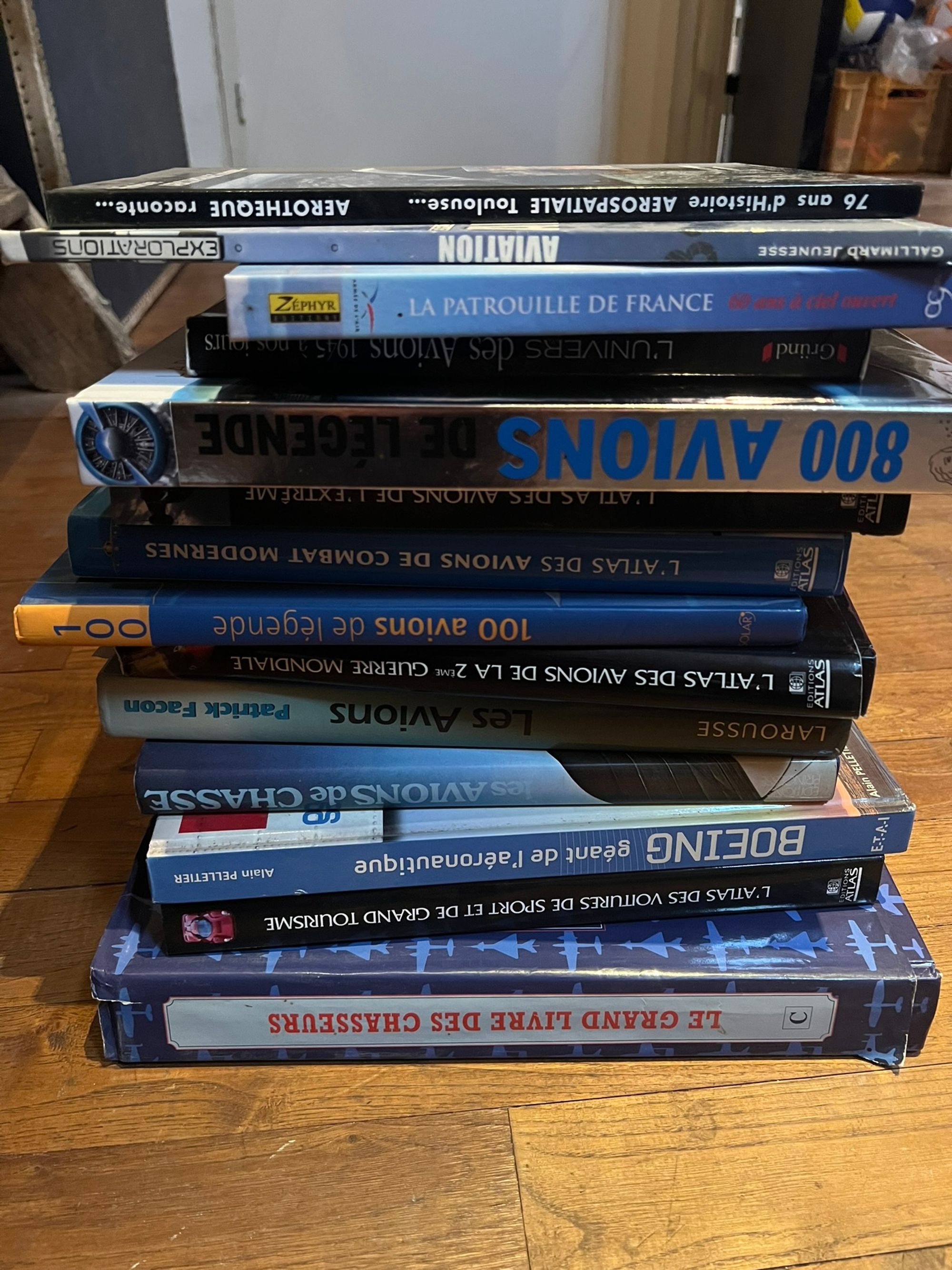 A stack of books on planes nearly as tall as myself (we’ll get back to that). Notice how I put them all upside-down.