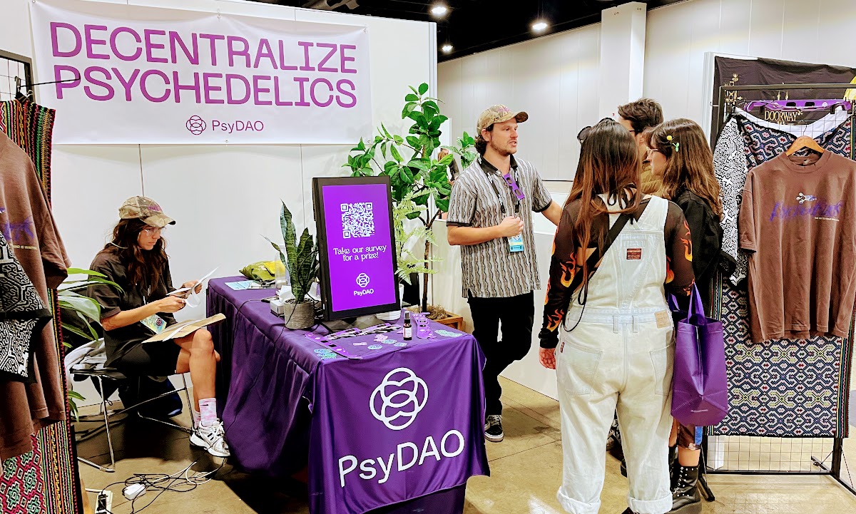 Our Creative Director, Brittney Scott, left, and Science Lead Tyler Quigley explain PsyDAO at the Psychedelic Science conference in Denver 2025.